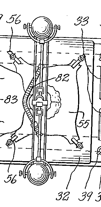 A close-up of a top-down view of the bed. A person's head rests on a pillow. A strap is across their neck, holding them to the pillow.